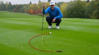 PGA pro Barney Puttick lining up a putt at Essendon Golf Club