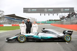 NORTHAMPTON, ENGLAND - FEBRUARY 23:Lewis Hamilton of Great Britain and Mercedes GP, Mercedes GP Executive Director Toto Wolff and Valtteri Bottas of Finland and Mercedes GP pose during the la