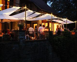 evening party with people, lighting and awning