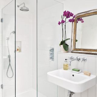 white wall bathroom with shower and washbasin