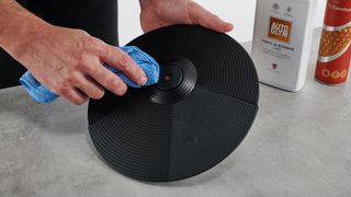 Cleaning an e-drum cymbal with a microfibre cloth