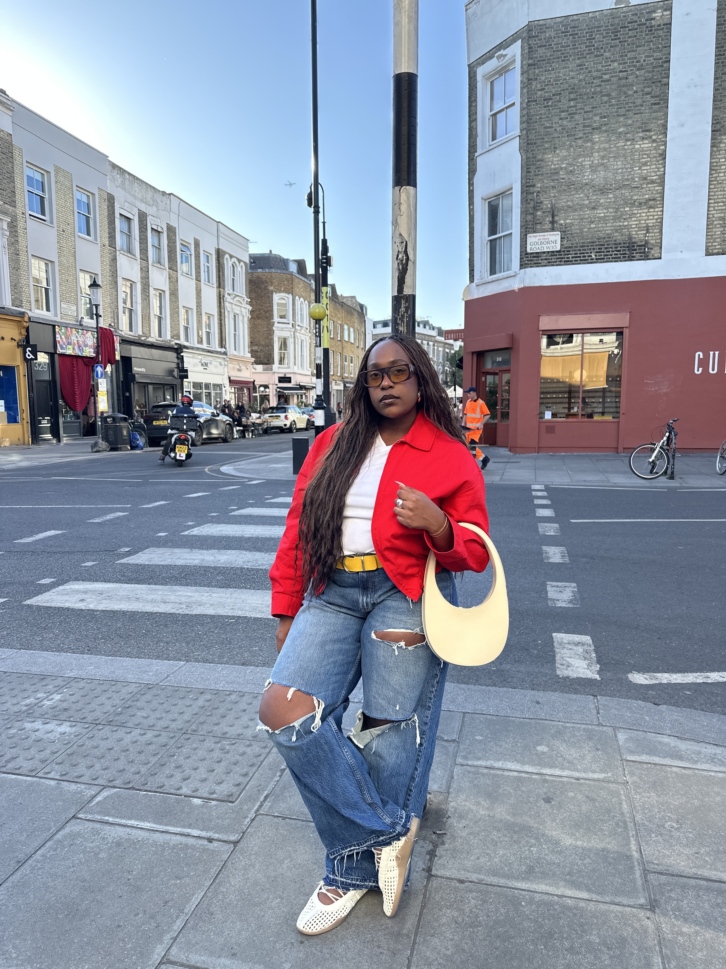 @aniyahmorinia wearing jeans, Adidas sneakers, white T-shirt, and a red jacket
