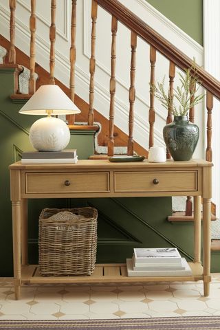 green hallway with wooden console table