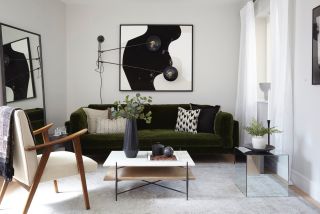 A living room with a smart sofa and monochrome artwork