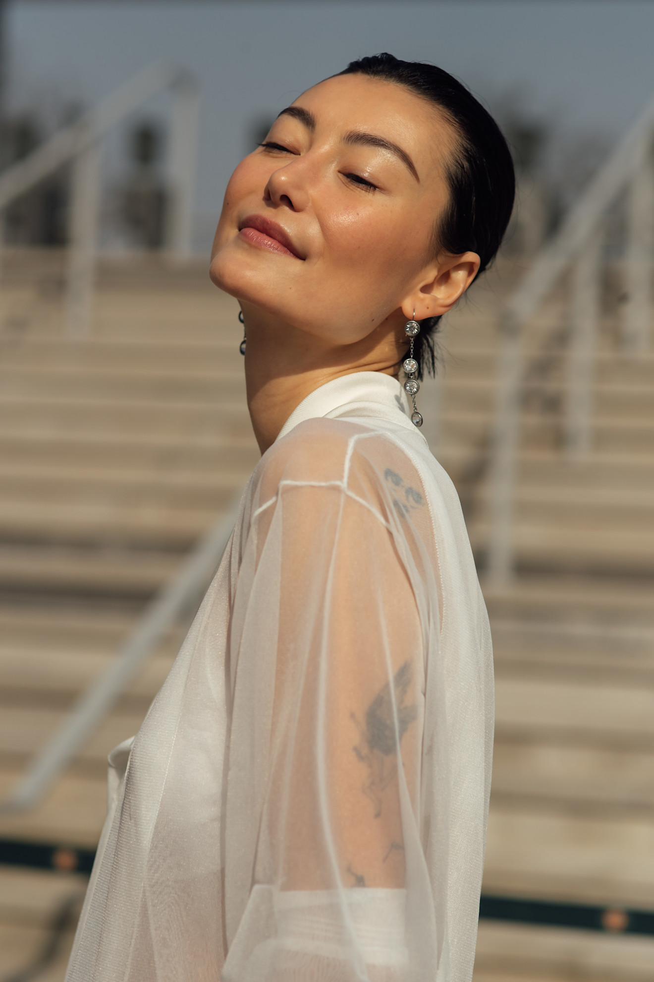 a woman in a white see-through shirt with glowing skin