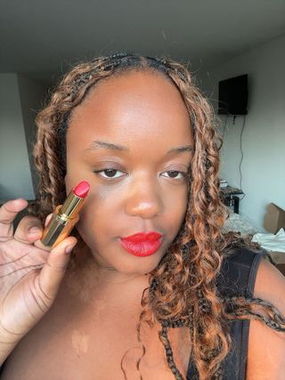 editor Ashe Delaney wears a red celine lipstick in front of her window