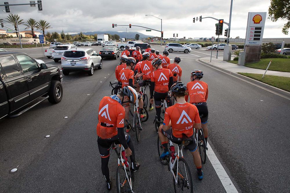 Rally UHC riders wait in traffic like proper cyclists