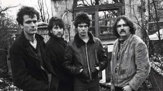 The Stranglers standing in a derelict house