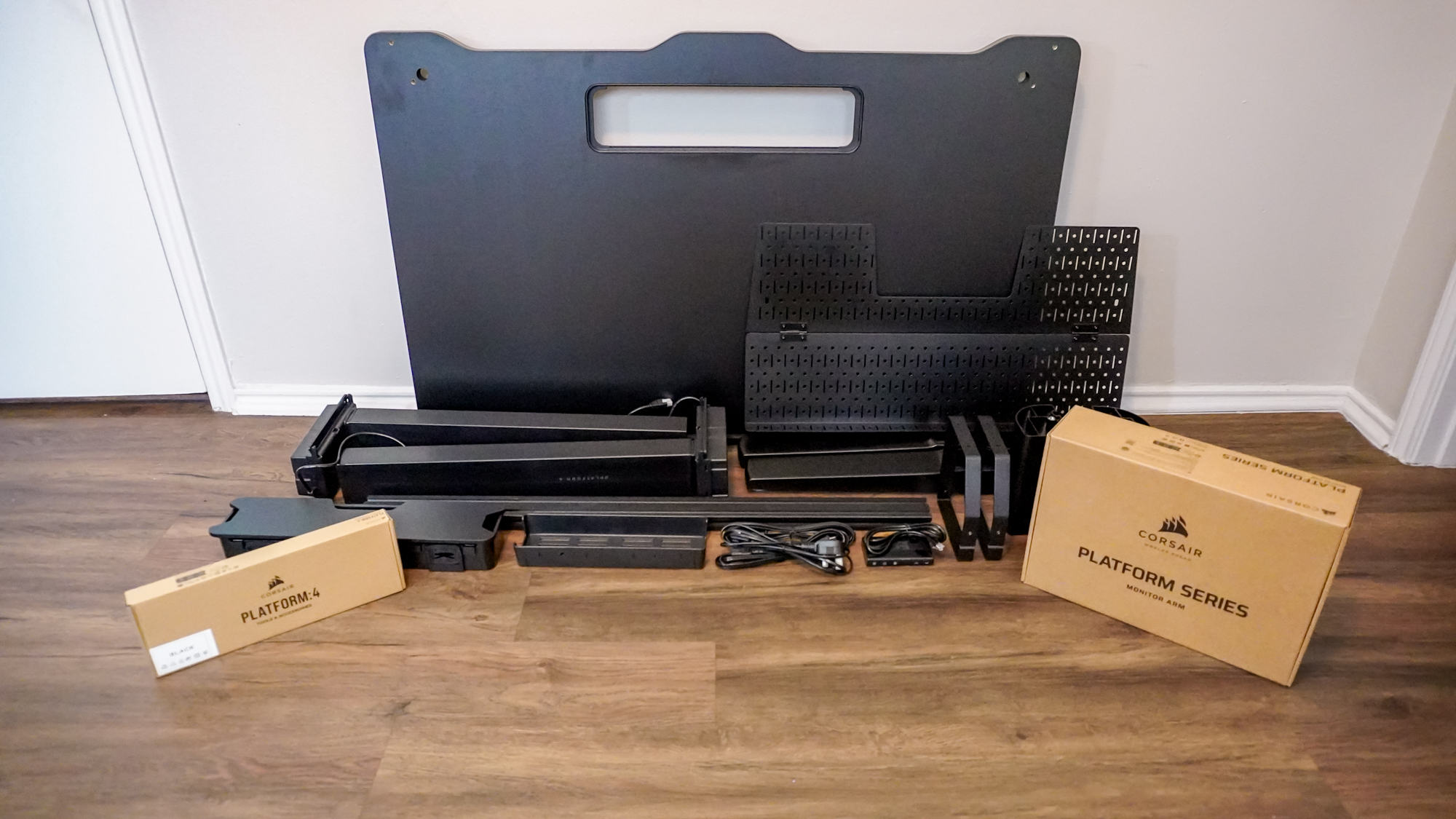 All the parts of the Corsair Platform 4: Elevate Desk laid out on the floor