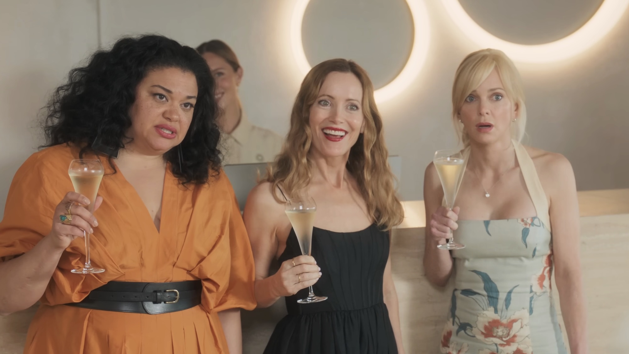 Coco, Jane and Sophie standing with champagne glasses in Spa Weekend