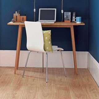 Study area with dark blue wall and wide white skirtings
