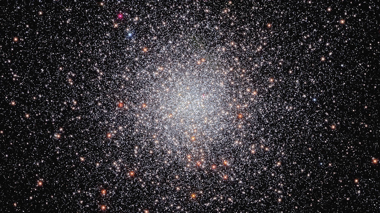 A image of a globular cluster located 28,000 light-years from Earth with the stars appearing as stellar bees in a cosmic bee hive.