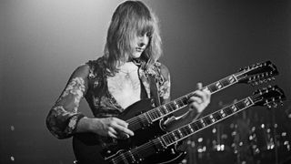 Alex Lifeson from the Canadian band Rush performs live on stage playing a Gibson EDS-1275 twin neck/double-neck guitar at the McMorran Arena in Port Huron, USA during their All the World&#039;s a Stage tour on 22nd May 1977.