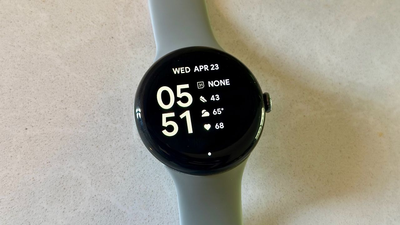 The Google Pixel Watch 3 on a white counter, showing the Index watch face.