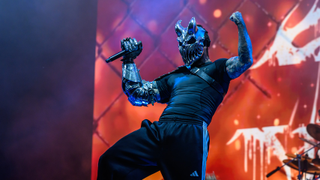 Alex Terrible in his mask posing on stage
