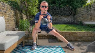 James Frew performing a kettlebell Cossack squat
