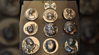 We see 10 silver phalerae on display in a museum. Two of them feature Medusa.