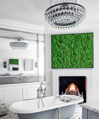 A white bathroom with chandelier, fireplace and contemporary artwork