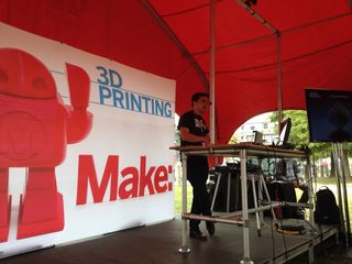 Made in Space co-founder and chief strategy officer Mike Chen discusses his company's 3D printer, which is launching to the International Space Station in 2014, with an audience at the 2013 World Maker Faire at the New York Hall of Science in New York City on Sept. 21, 2013.