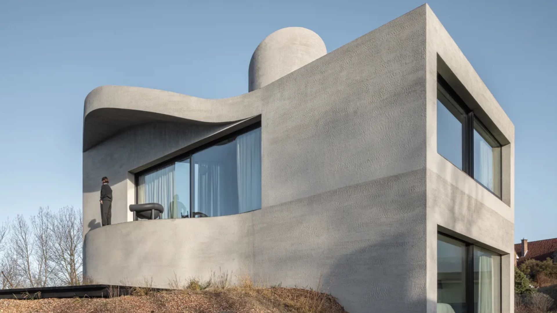 Tour a curvy concrete seaside villa moored in the North Sea dunes