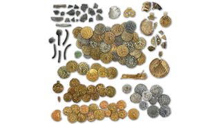 A picture of a coin hoard with many gold and silver coins