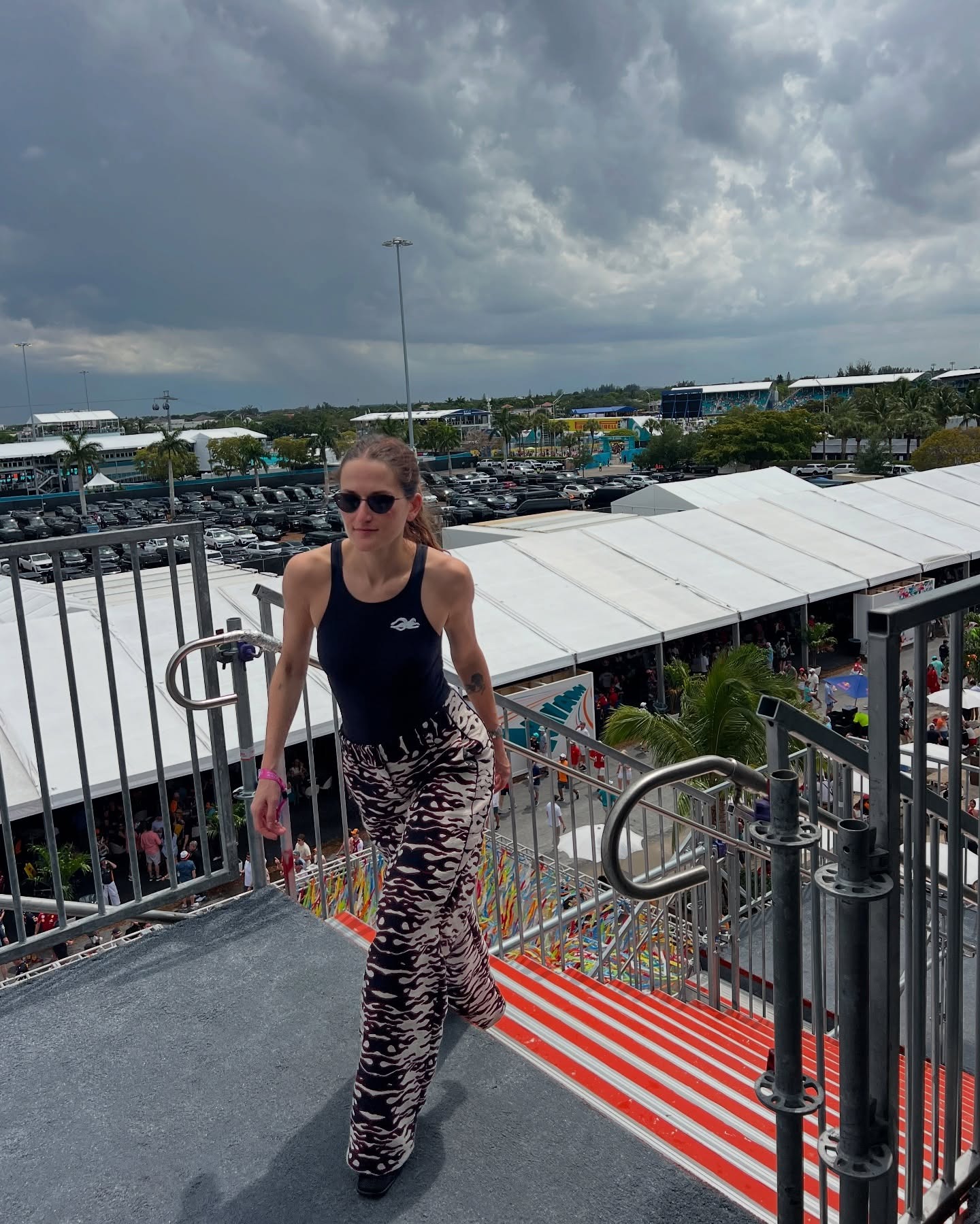 Eliza Huber wearing a black bodysuit and flame-print pants by Tory Burch at the Miami Grand Prix.