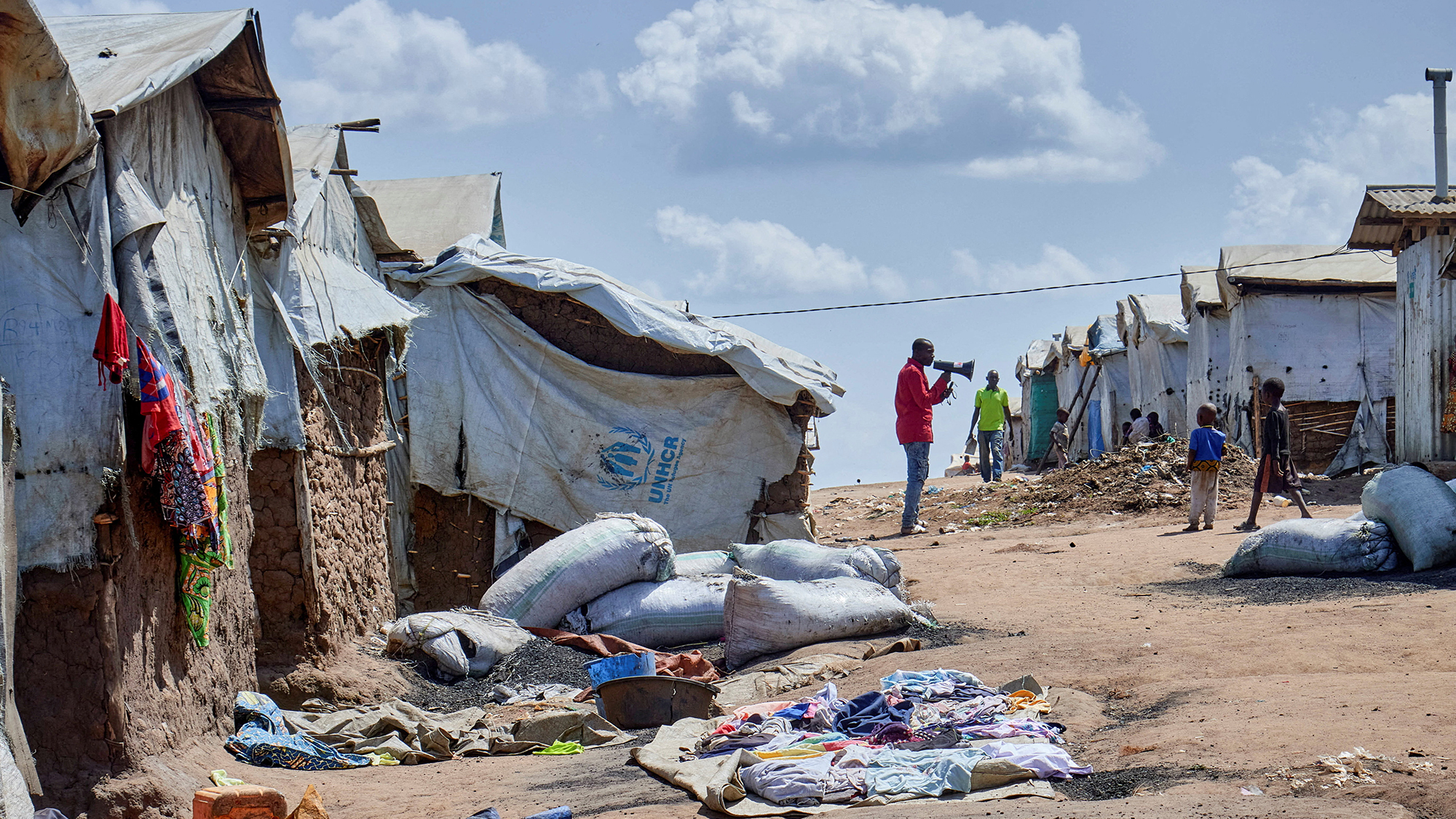 A supervisor at the Kigonze camp for internally displaced persons urges residents to wash their hands as fears grow over the spread of Ebola, in Bunia, Democratic Republic of Congo
