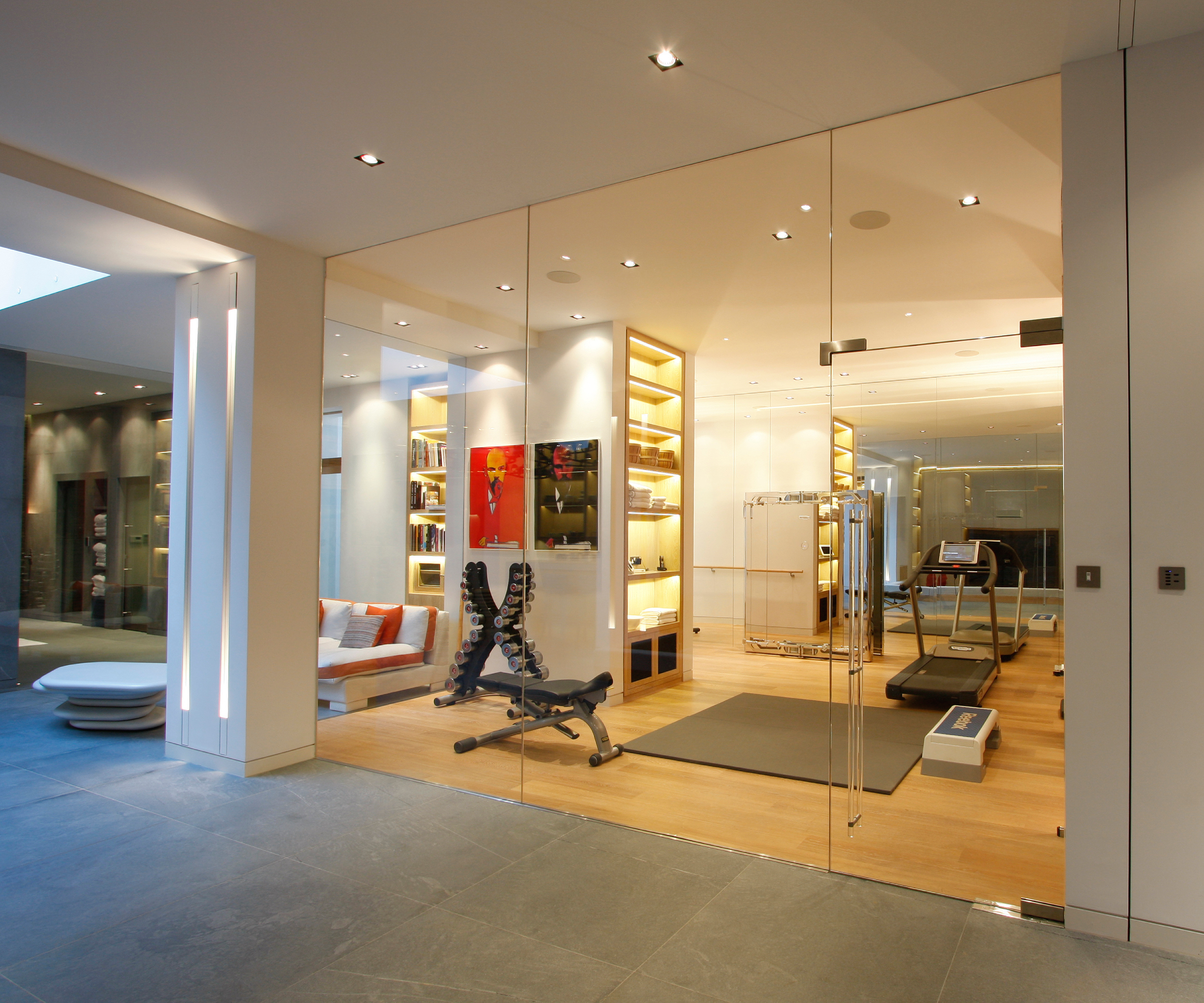 frameless glass wall in basement gym room