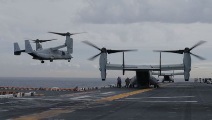 A Marine MV-22B Osprey aircraft lands on the deck of the USS Bonhomme Richard amphibious assault ship