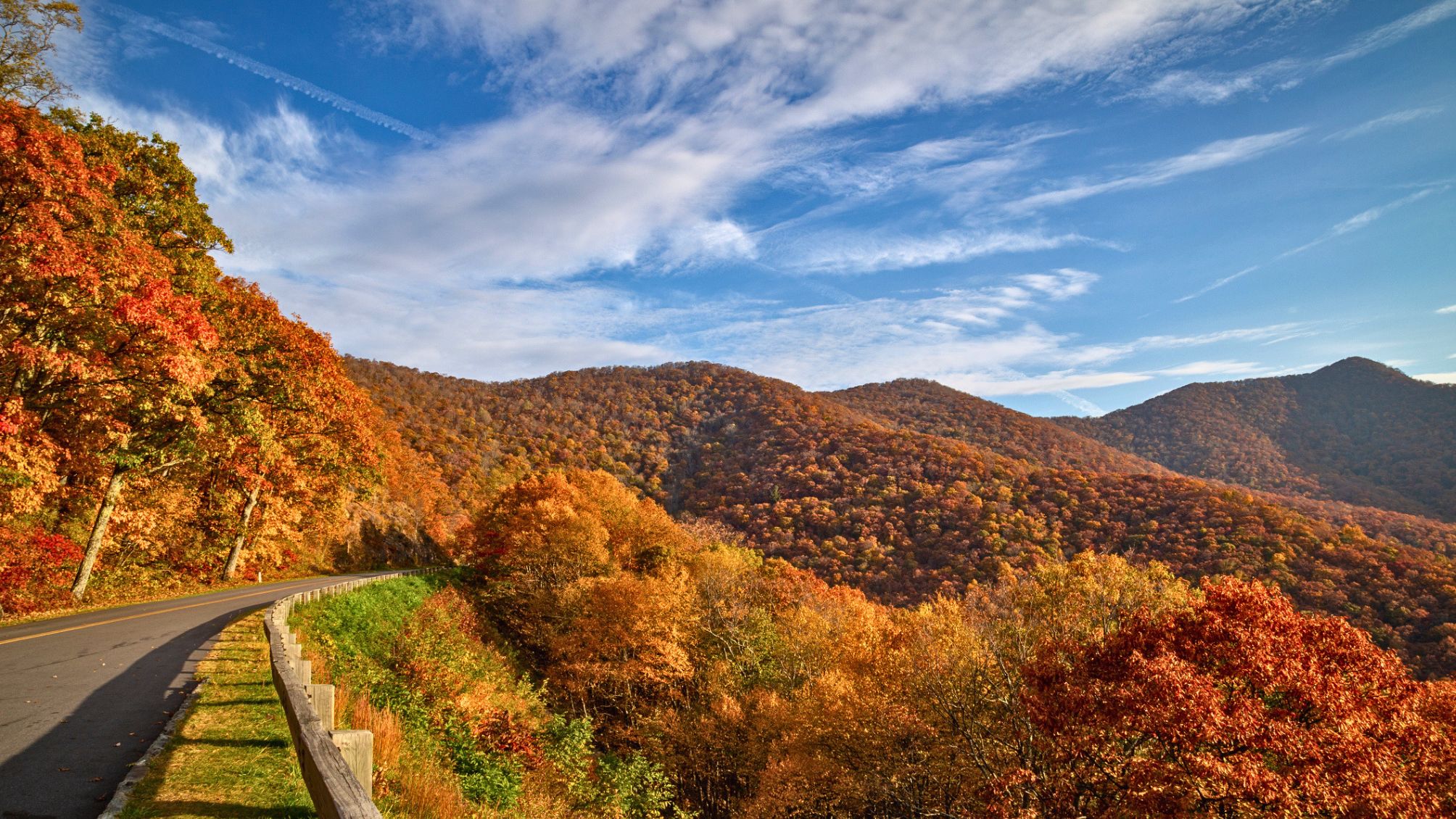 An autumn blaze of color emerges from the mountainside of the Blue Ridge Parkway in North Carolina, USA.