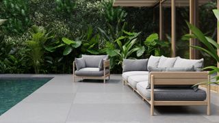 Best outdoor furniture teak framed grey cushioned sofa beside a pool