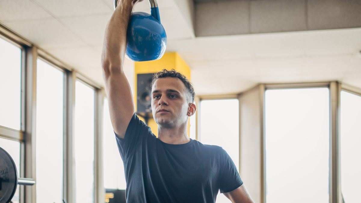 Man performing the kettlebell viper press