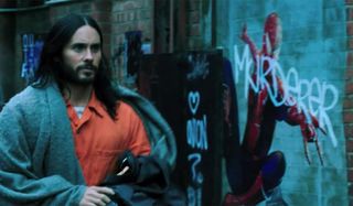 Jared Leto walks past some Spider-Man graffiti in Morbius.