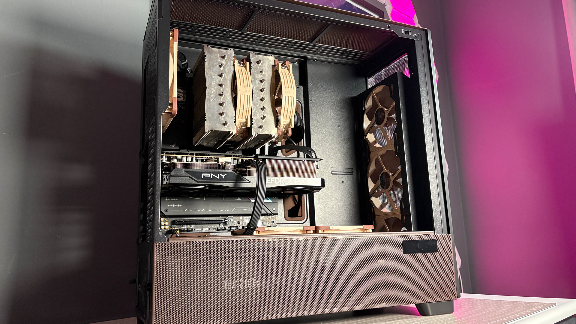 The Antec Flux Pro Noctua Edition on a desk with various parts disassembled.