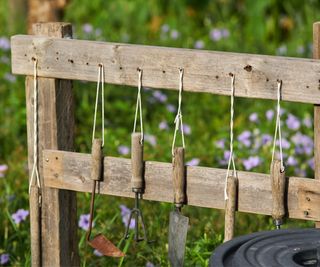 garden tools on homemade wooden rack