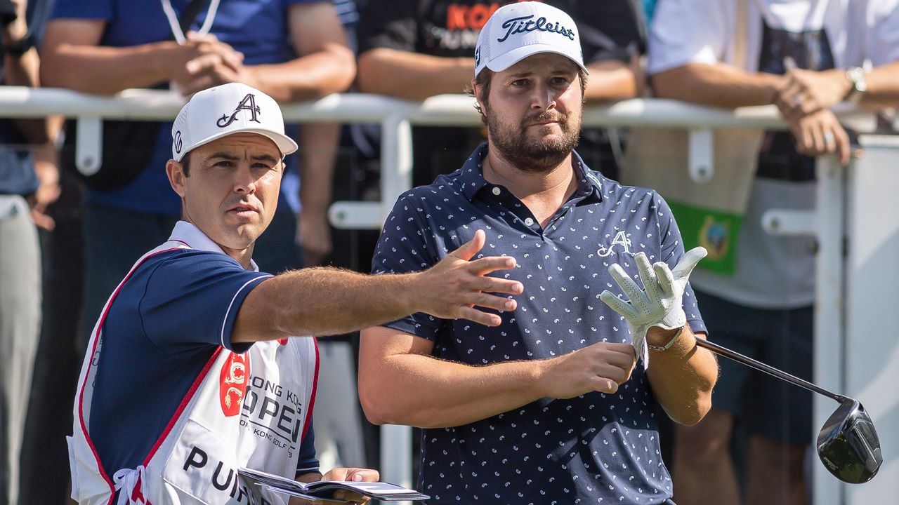 Peter Uihlein and his caddie discuss a tee shot