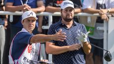 Peter Uihlein and his caddie discuss a tee shot