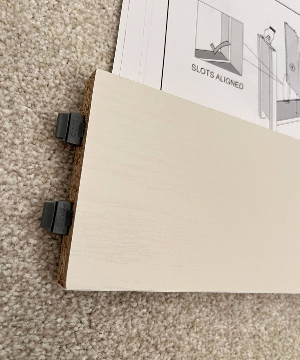 piece of furniture with dark grey plastic fixings at one end