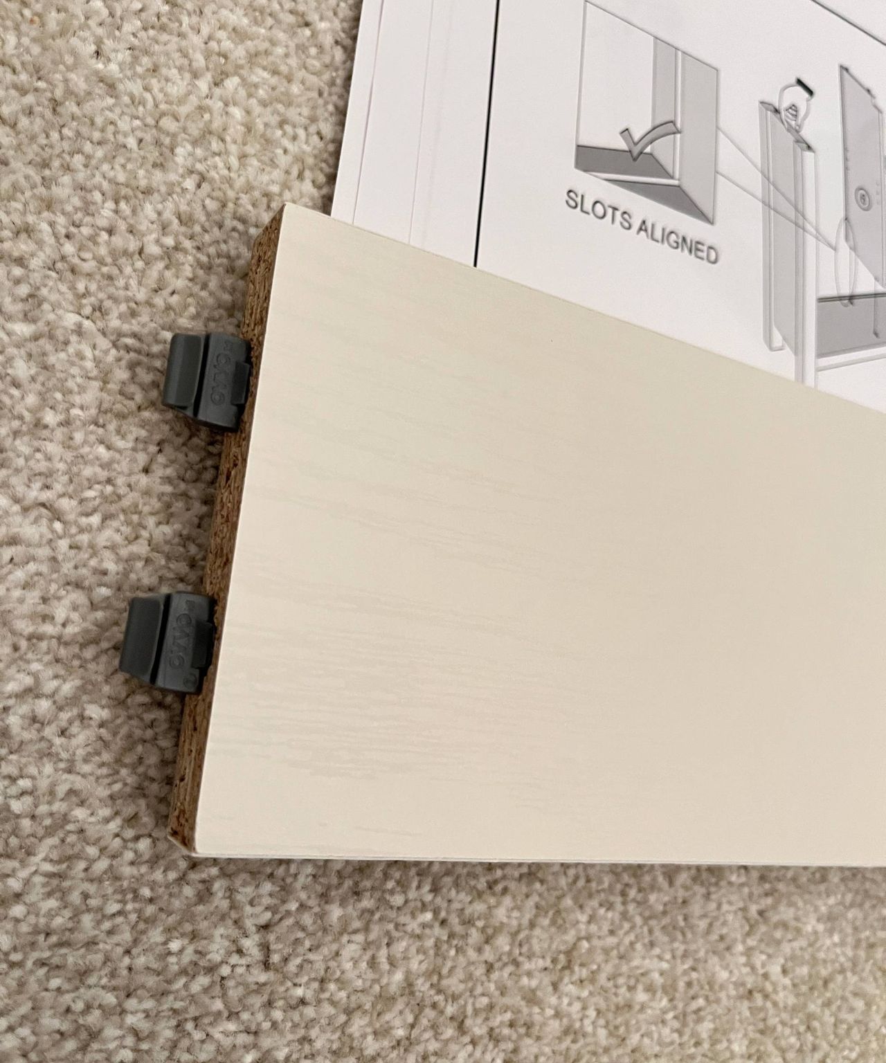 piece of furniture with dark grey plastic fixings at one end