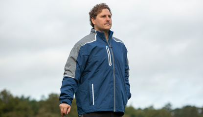 A golfer wears the ProQuip StormForce PX8 Rain Jacket