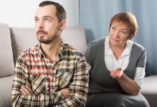 Aged mother arguing with her adult son at home