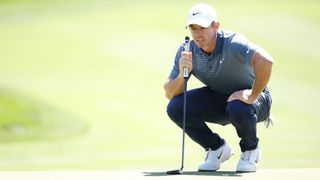 Rory McIlroy reading a green during The Players Championship