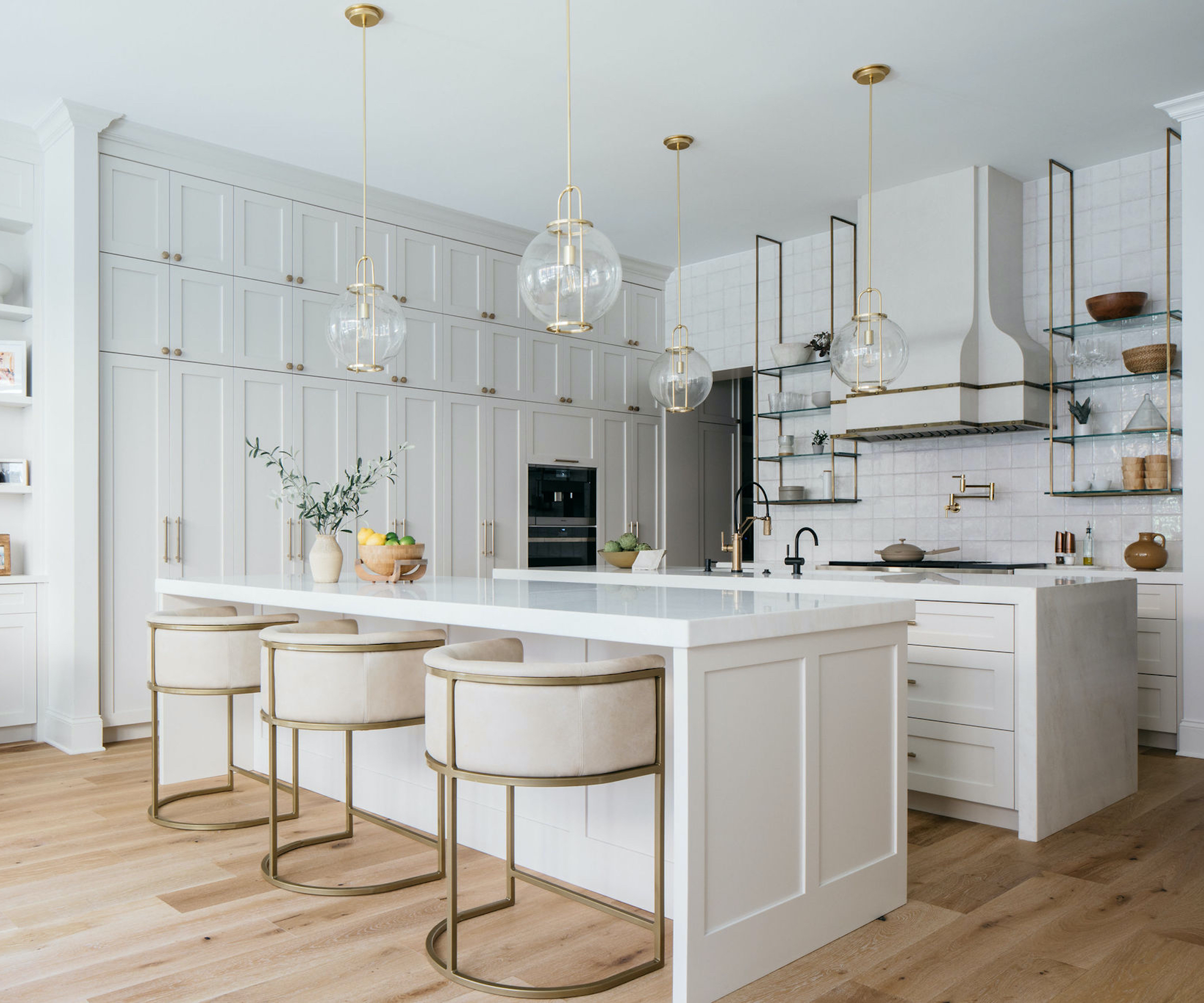 white kitchen with two islands and wood floors