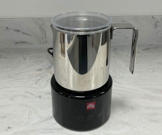 illy electric milk frother on countertop