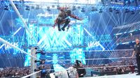 Scenes from WWE Wreslemania 42 with wrestlers making entrances in front of huge digital displays. 