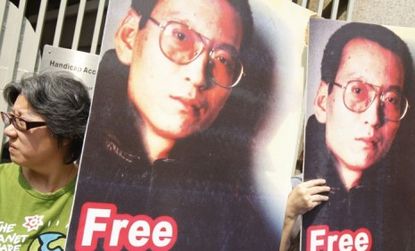 Protesters hold signs demanding the release of Chinese dissident, and now Nobel peace prize winner, Liu Xiaobo from his 11-year jail sentence.