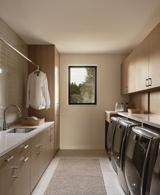 a modern laundry room with a hanging clothes rail