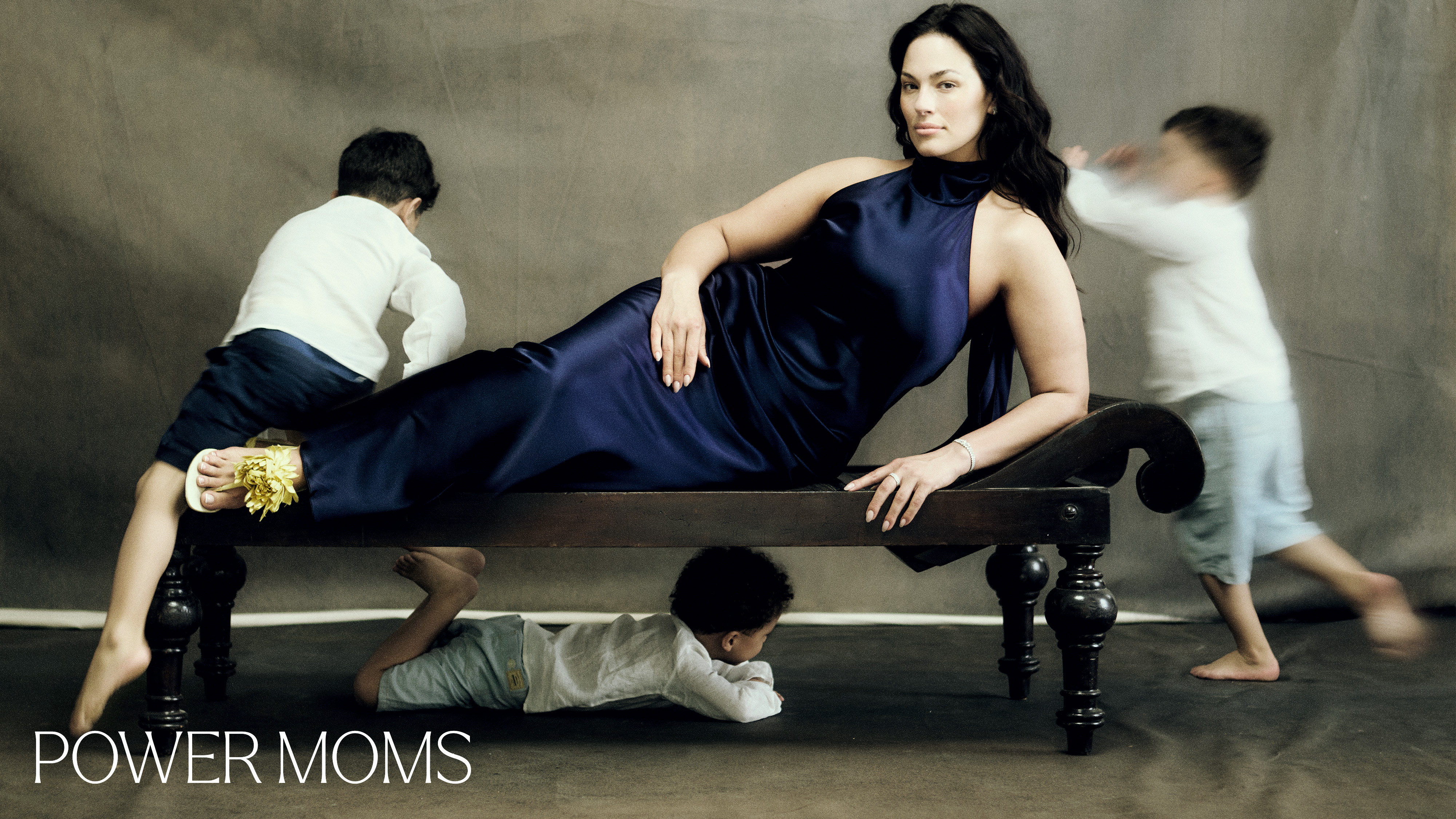 Ashley Graham surrounded by her children with the overlaid text "power moms"