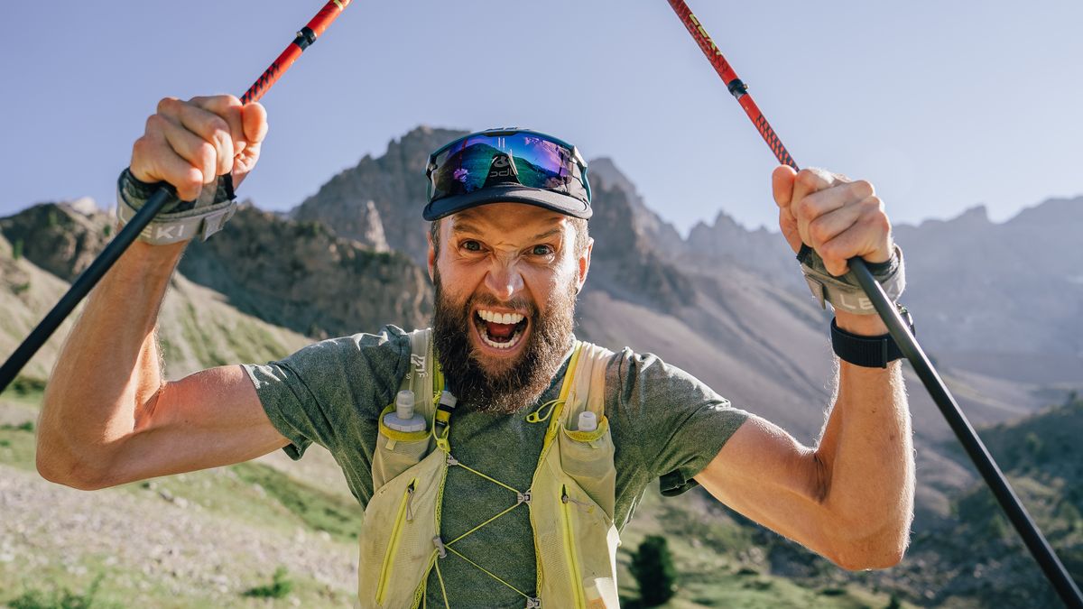 Ultra runner Jake Catterall holding his running poles up