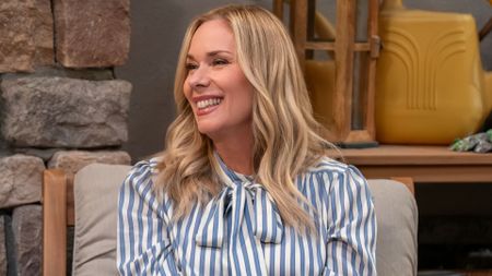 Leanne smiles at something offscreen